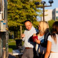 Families ordering at Righteous Cuisine food truck.